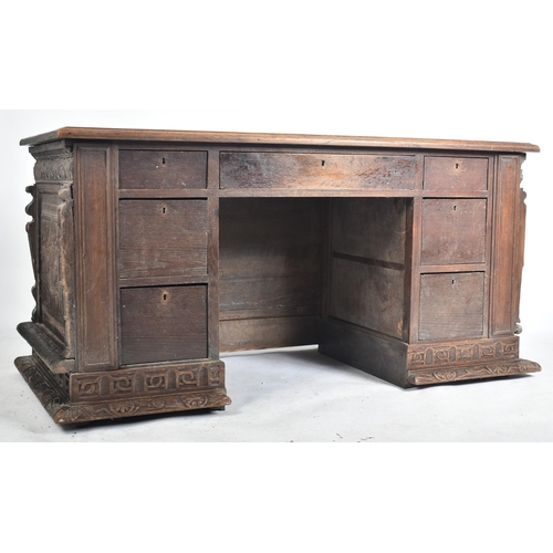 75 - A 17th century carved Italian large Cassone converted to a desk. The heavily carved front panel in r... 