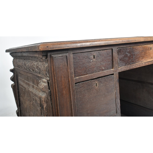 75 - A 17th century carved Italian large Cassone converted to a desk. The heavily carved front panel in r... 