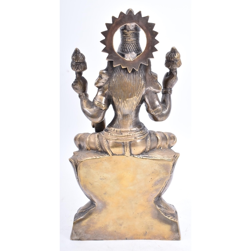 78 - An Indian heavy brass handmade Goddess Lakshmi/Laxmi statue modelled with 2 pairs of arms, one pair ... 