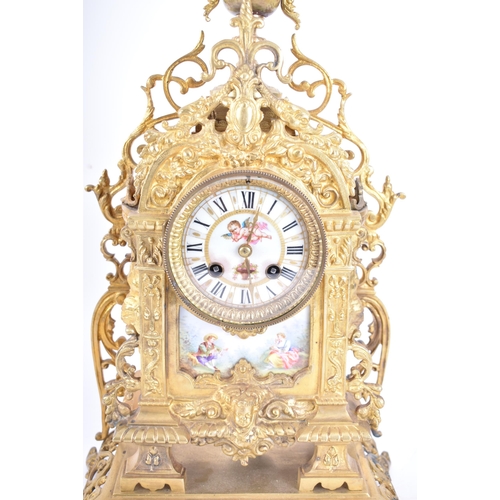 79 - A 19th century French gilt brass and enamel porcelain painted mantel clock. The cylinder head clock ... 