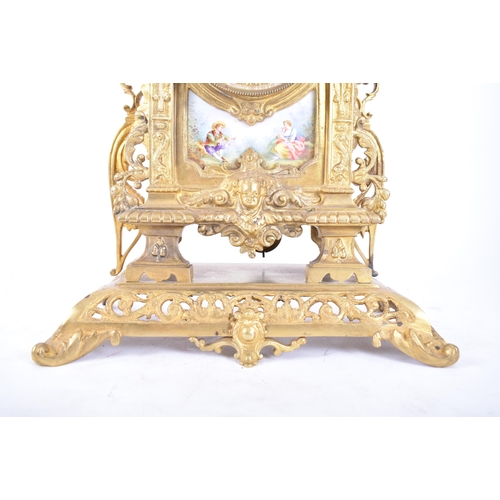 79 - A 19th century French gilt brass and enamel porcelain painted mantel clock. The cylinder head clock ... 