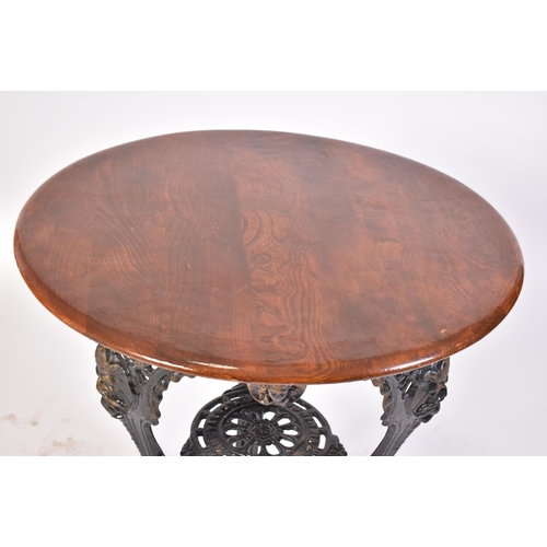 82 - A 19th century Victorian oak top cast iron pub / bistro table. The table of circular form with an oa... 