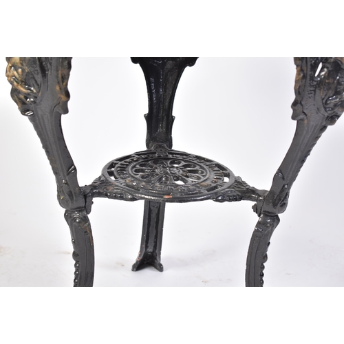 82 - A 19th century Victorian oak top cast iron pub / bistro table. The table of circular form with an oa... 