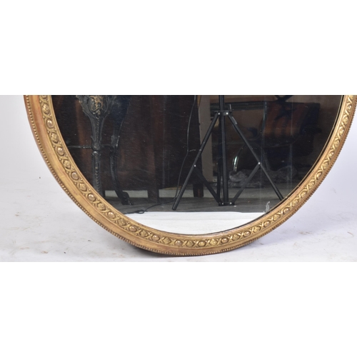 95 - A large late 19th century Victorian gilt framed mirror. The mirror of circular form with beaded edge... 