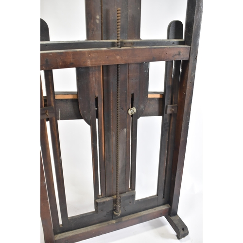 99 - A large Victorian 19th century black painted wood studio artist's easel. The easel raised on brass c... 