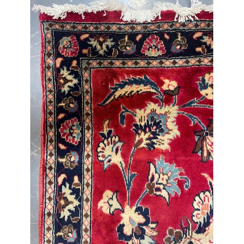 71 - A 20th century Central Persian Islamic Kashan floor carpet runner rug. The rug in a silk red ground ... 