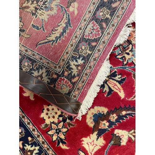 71 - A 20th century Central Persian Islamic Kashan floor carpet runner rug. The rug in a silk red ground ... 