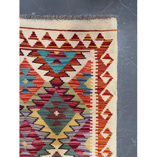 98 - A 20th century Anatolian Turkish Islamic Kilim floor carpet runner rug. The rug having a a central p... 