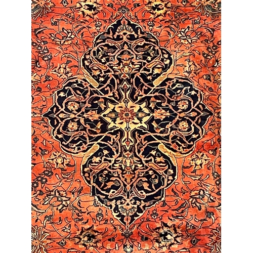 137 - An early 20th century North West Persian Islamic Sarouk floor carpet rug. The rug having a central f... 