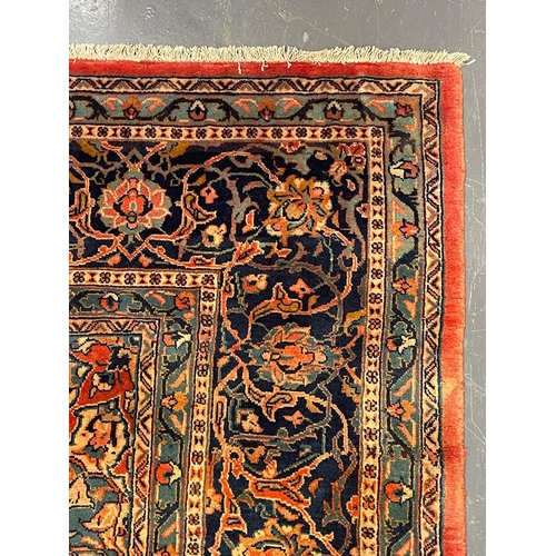 137 - An early 20th century North West Persian Islamic Sarouk floor carpet rug. The rug having a central f... 