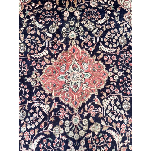 147 - An early 20th century North West Persian Islamic Sarouk carpet rug. The rug having a central blue me... 