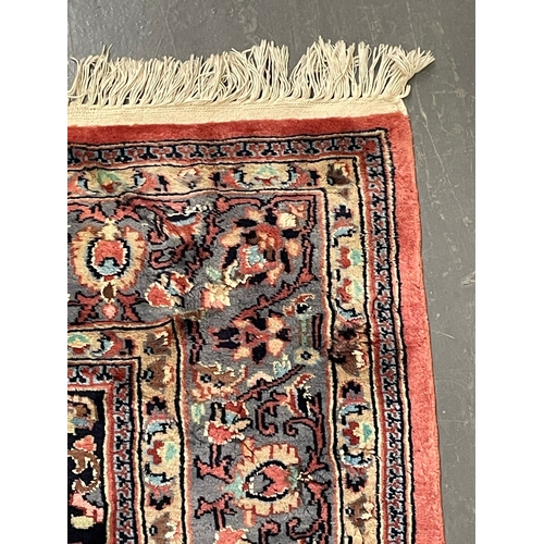 168 - A 20th century Persian Islamic Abousson style floor carpet rug. The rug on a pink wool background de... 