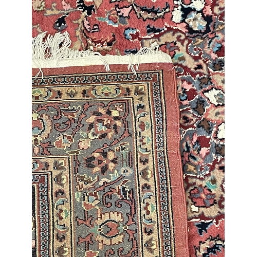 168 - A 20th century Persian Islamic Abousson style floor carpet rug. The rug on a pink wool background de... 