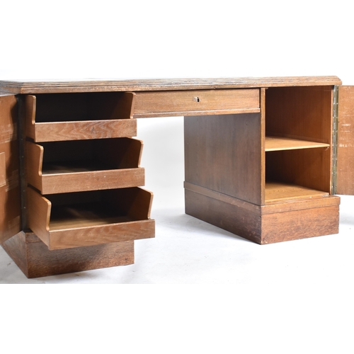 301 - An Art Deco early 20th century circa 1930s oak & leather top office writing desk table. The desk hav... 