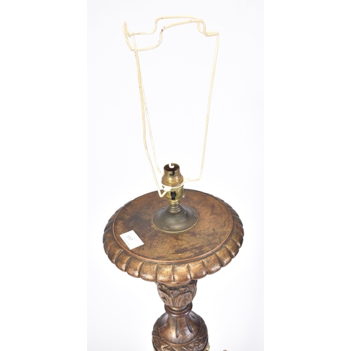 317 - An early 20th century gilt wood tripod standard floor lamp. Gilt reeded tapering body with carved co... 