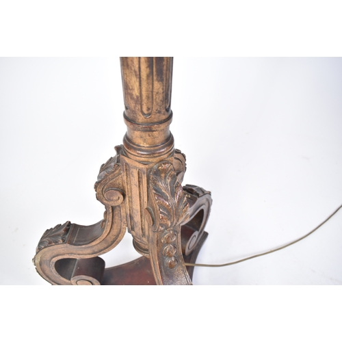 317 - An early 20th century gilt wood tripod standard floor lamp. Gilt reeded tapering body with carved co... 