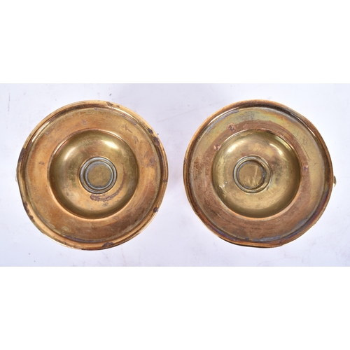 324 - A pair of mid-late 19th century brass candle stick holders / nightlights. Each with finger ring and ... 