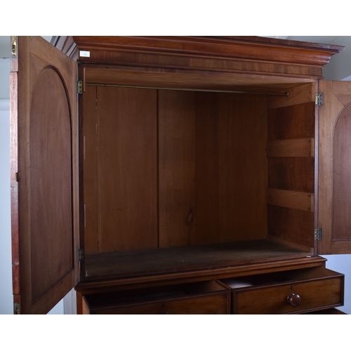 334 - A Victorian 19th century mahogany linen press cupboard. The press having a pediment top over double ... 