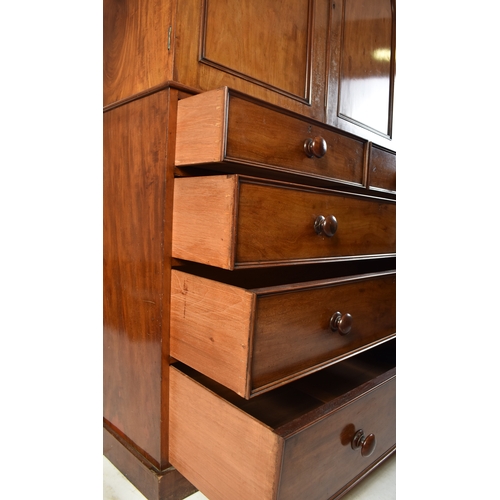 334 - A Victorian 19th century mahogany linen press cupboard. The press having a pediment top over double ... 