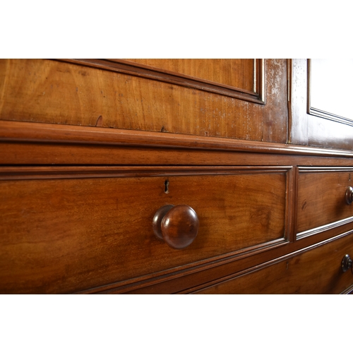 334 - A Victorian 19th century mahogany linen press cupboard. The press having a pediment top over double ... 