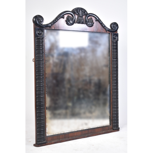 403 - A Regency period early 19th century ebonised wood & rosewood over mantle mirror. The mirror having a... 