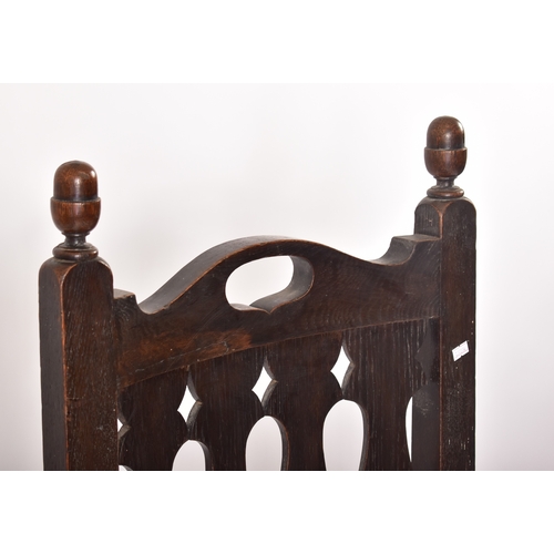 405 - A Victorian 19th century oak & leather throne hall chair. The chair having cup & cover shaped finial... 