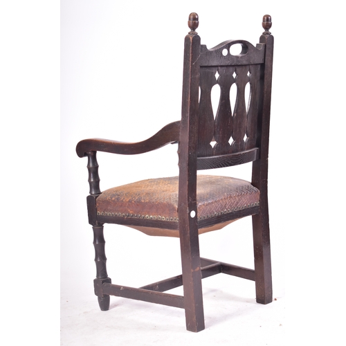 405 - A Victorian 19th century oak & leather throne hall chair. The chair having cup & cover shaped finial... 