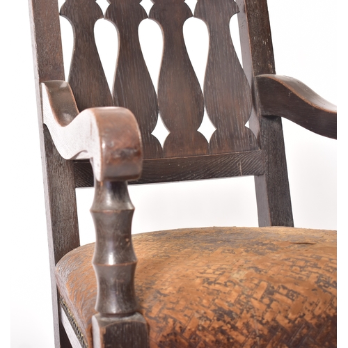 405 - A Victorian 19th century oak & leather throne hall chair. The chair having cup & cover shaped finial... 