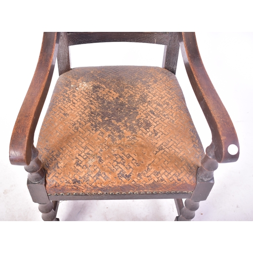 405 - A Victorian 19th century oak & leather throne hall chair. The chair having cup & cover shaped finial... 