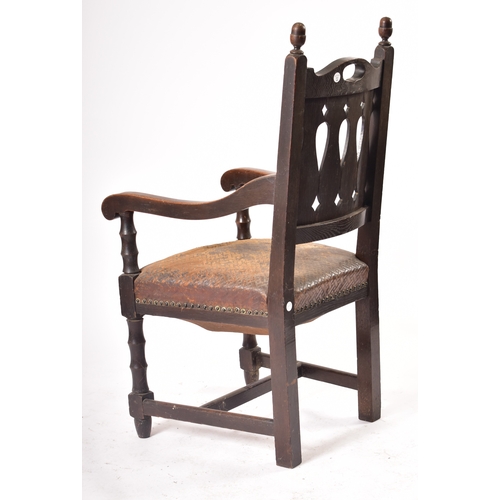 405 - A Victorian 19th century oak & leather throne hall chair. The chair having cup & cover shaped finial... 