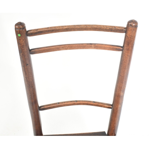 413 - A Victorian 19th century elm child's rocking chair. The chair having a ladder back with turned side ... 