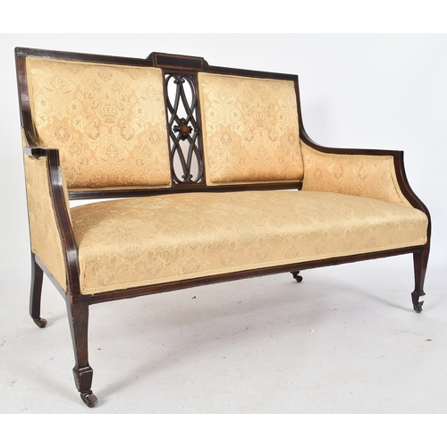 419 - An Edwardian mahogany inlaid two seater sofa settee / salon sofa. The sofa having a twin panel padde... 