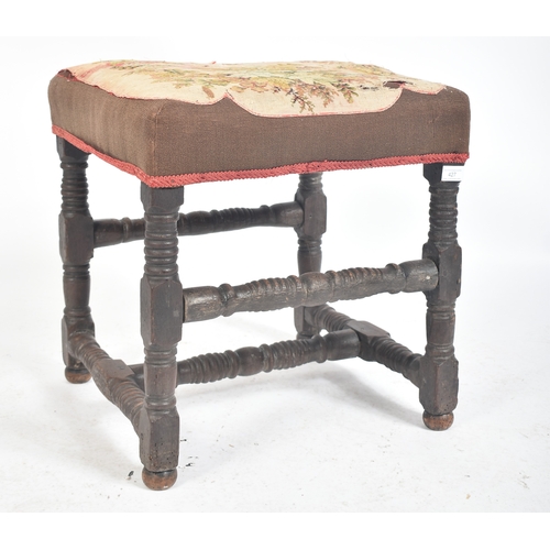 427 - An 18th century English oak and tapestry upholstered stool. The stool with tapestry overstuffed seat... 