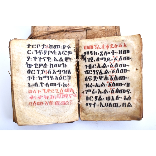 434 - An early 20th century Ethiopian Coptic manuscript prayer book bound in hardwood boards with vellum l... 