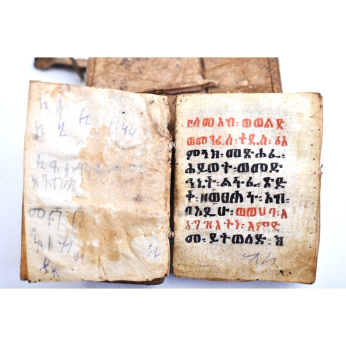 434 - An early 20th century Ethiopian Coptic manuscript prayer book bound in hardwood boards with vellum l... 