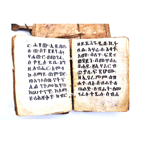 434 - An early 20th century Ethiopian Coptic manuscript prayer book bound in hardwood boards with vellum l... 