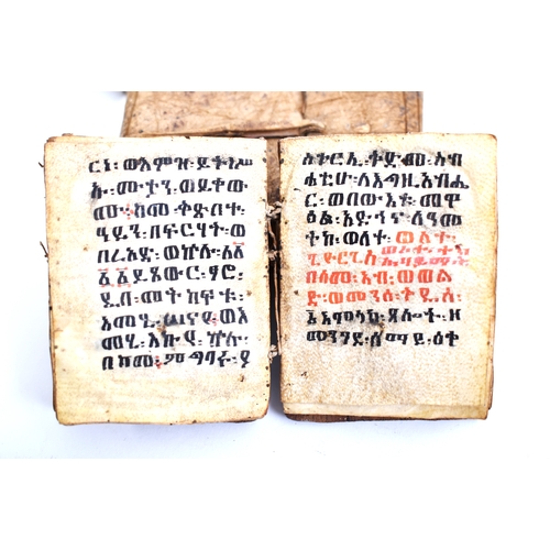 434 - An early 20th century Ethiopian Coptic manuscript prayer book bound in hardwood boards with vellum l... 