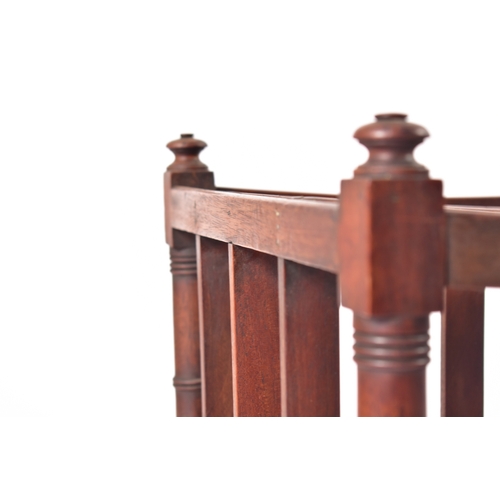 437 - A George III 19th century mahogany magazine rack. The rack having four turned finials atop over a fo... 