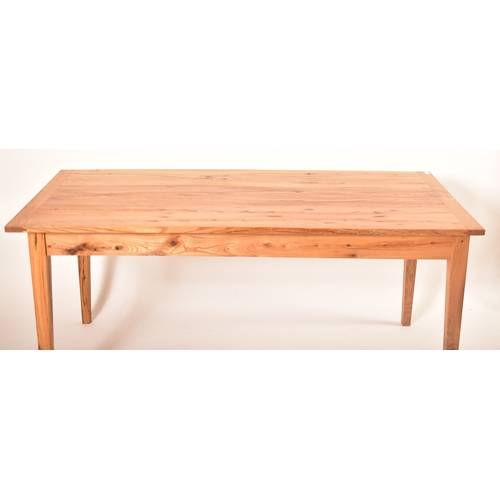 440 - A late 20th century elm wood refectory farmhouse dining table. The table having a rectangular square... 