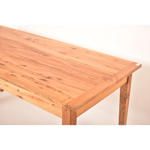 440 - A late 20th century elm wood refectory farmhouse dining table. The table having a rectangular square... 