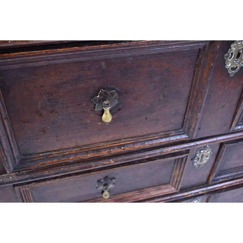 443 - A 17th century commonwealth oak block fronted chest of drawers. Raised on stile legs with short and ... 