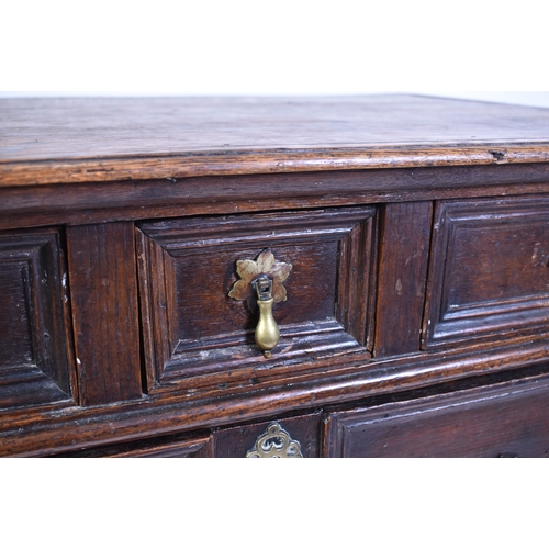 443 - A 17th century commonwealth oak block fronted chest of drawers. Raised on stile legs with short and ... 