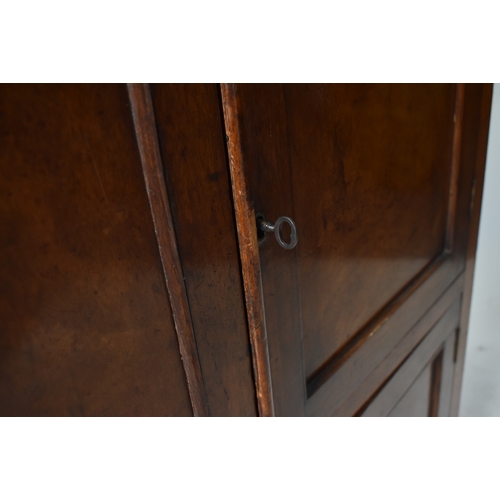 445 - An early 20th century 1900s mahogany twin door school - estate cupboard. Raised on a plinth base wit... 