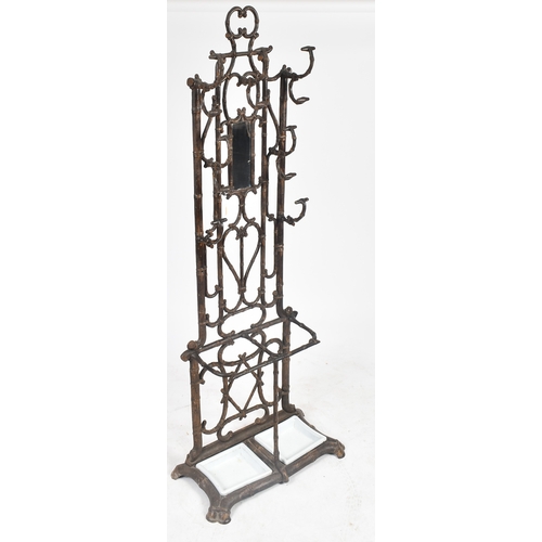 447 - A vintage Coalbrookdale manner faux bamboo cast iron hall stand. The stand having an elaborate back ... 