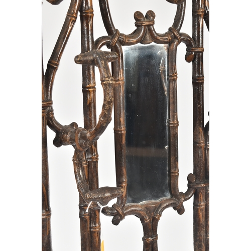 447 - A vintage Coalbrookdale manner faux bamboo cast iron hall stand. The stand having an elaborate back ... 