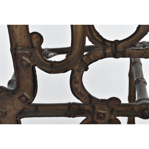 447 - A vintage Coalbrookdale manner faux bamboo cast iron hall stand. The stand having an elaborate back ... 