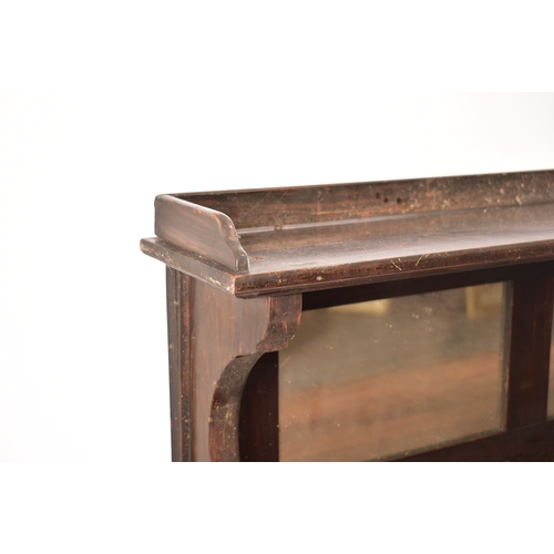 450 - A 19th century rosewood credenza having an open window bookcase with arched top flanked by end glass... 