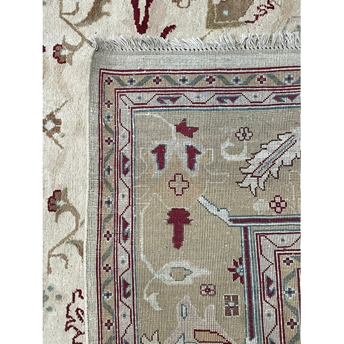 485 - A large early 20th century Afghan Islamic Ziegler floor carpet rug. The rug in a cream & red colourw... 