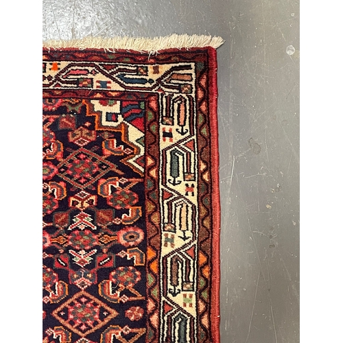 274 - A 20th century Persian Islamic Belouch floor carpet runner rug. The rug having a series of three geo... 