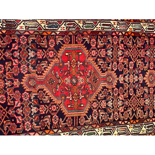 274 - A 20th century Persian Islamic Belouch floor carpet runner rug. The rug having a series of three geo... 